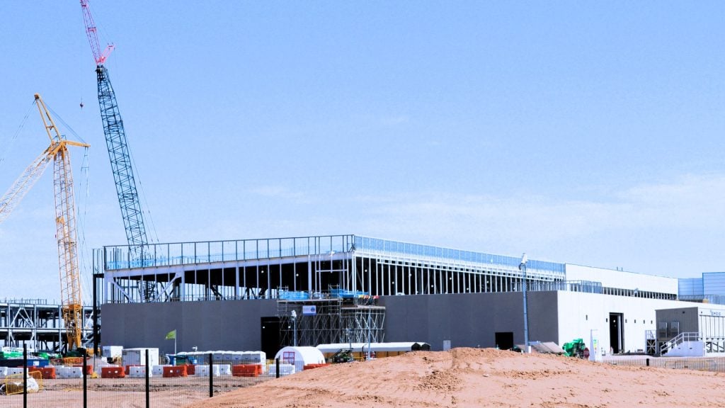 Large data centre facility under a clear blue sky