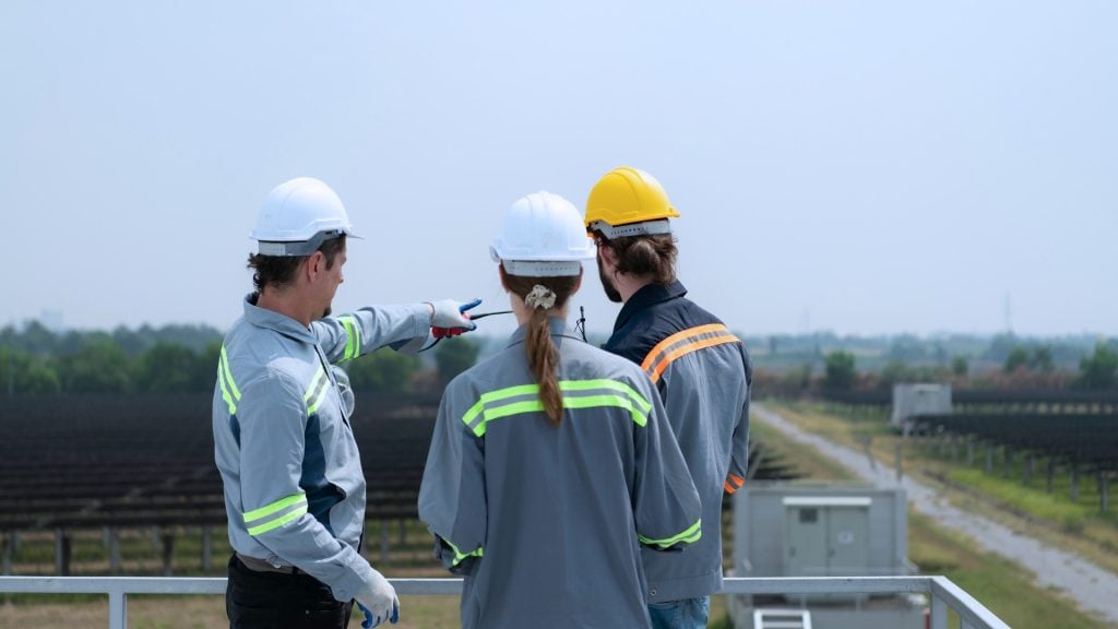 Engineers discussing plans at an outdoor construction site