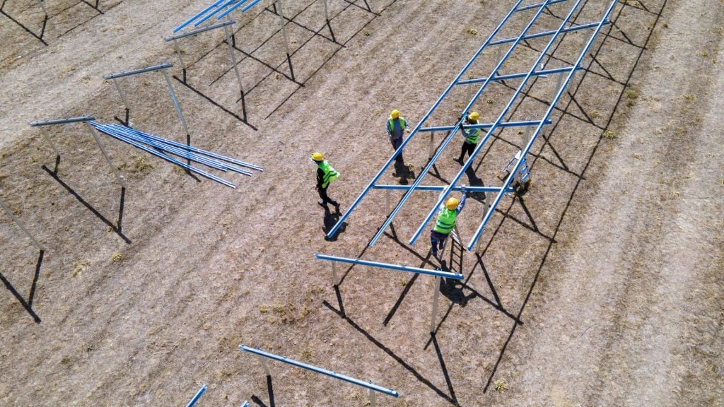 Construction workers installing steel reinforcement on a building site